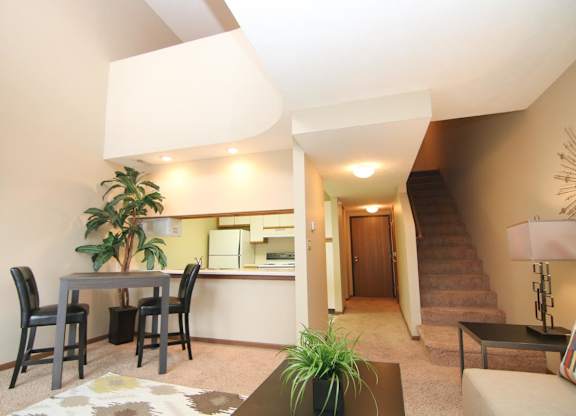 A living room with a dining table and chairs.