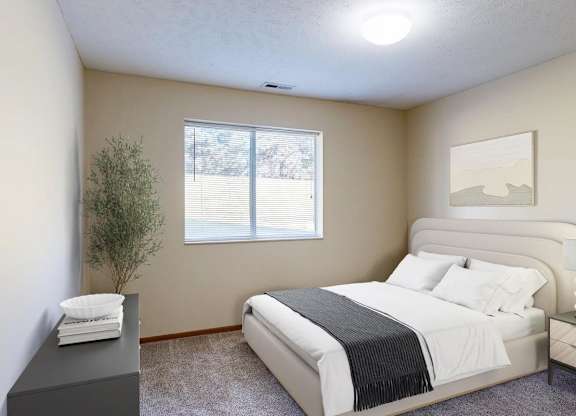 A bedroom with a large bed and a lamp on the nightstand.