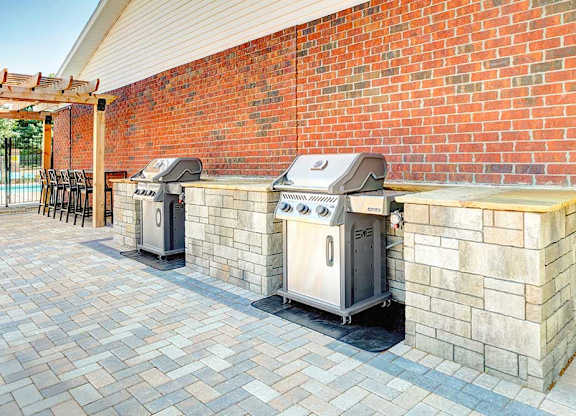 Two outdoor grilling stations with stone counters, perfect for grilling up your favorite recipes.