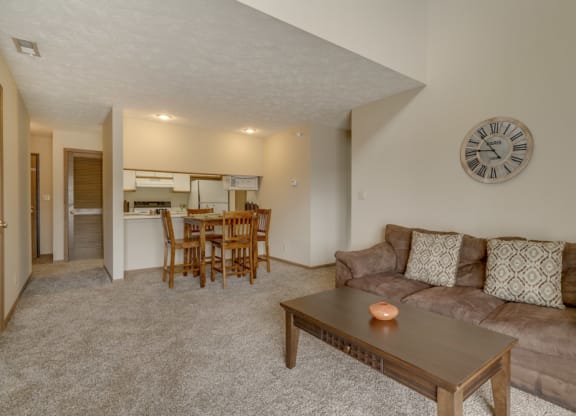 Living room in loft style apartment with view into the kitchen off of dining area