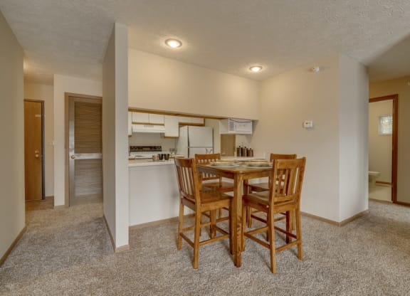 Dining area and kitchen view at Pine Lake Heights Apartments