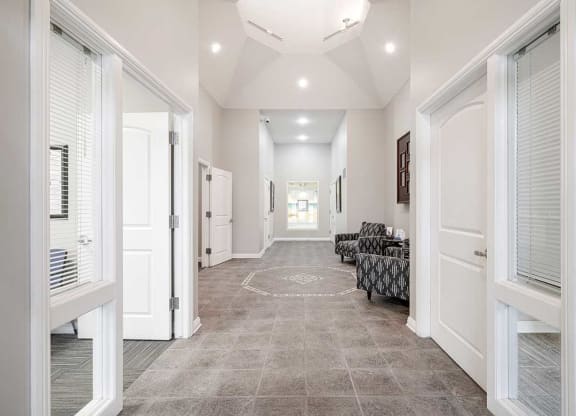 an open lobby space with an office space off to each side
