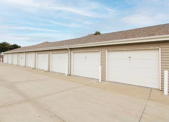A row of nine garages with white garage doors