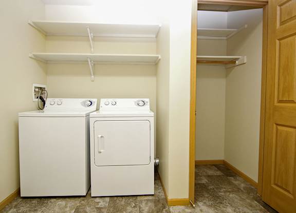 A small laundry room with a washer and dryer.
