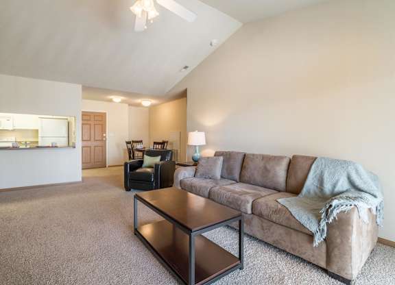 A living room with a couch, chair, and coffee table.