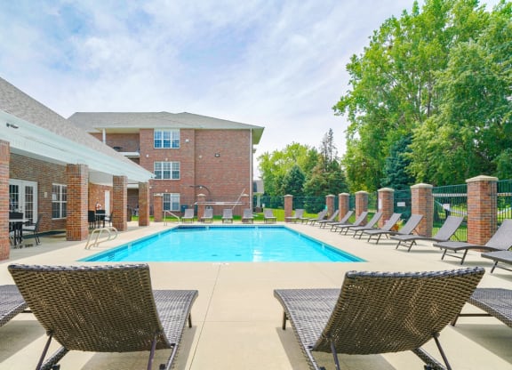 Swimming pool with lounge chairs for sunbathing