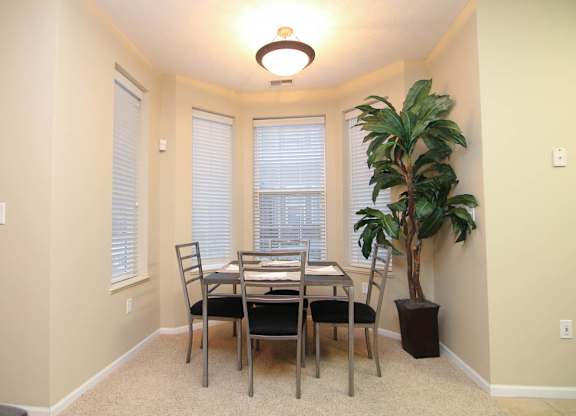 A dining room with a table and chairs.