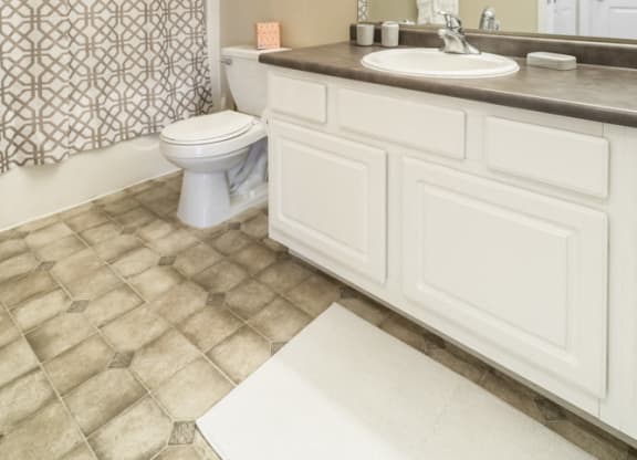 Interiors-Bathroom with white cabinetry and bathtub at Ridge Pointe Villas