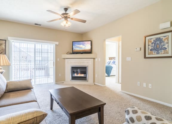 Interiors-Living room view of 1-bedroom townhome with balcony at Ridge Pointe Villas