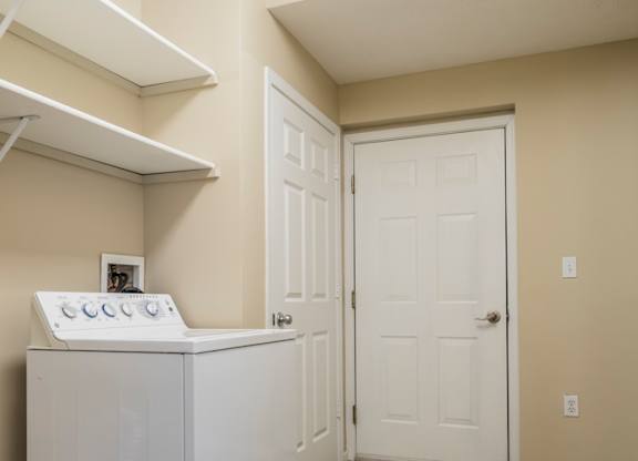 A laundry room and mud room with a full-sized washer and dryer.