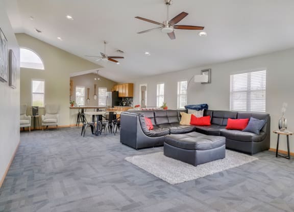 Common area with lounge area and kitchen in the clubhouse at Skyline View apartments