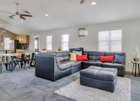 Common area with lounge area and kitchen in the clubhouse at Skyline View apartments