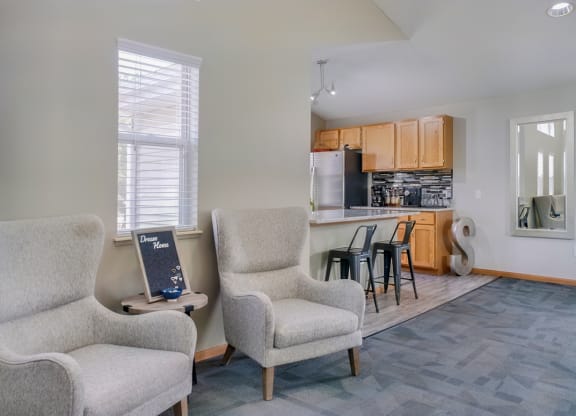 Lounge space with chairs near the kitchen in the clubhouse at Skyline View