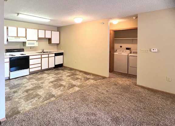 a kitchen with white cabinets and appliances