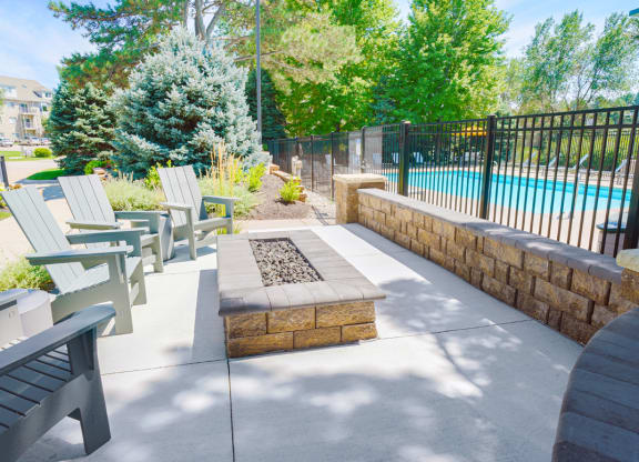 outdoor fire pit with seating outside of gated community pool