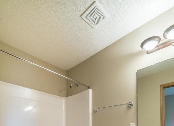 A white toilet sits next to a sink in a bathroom.