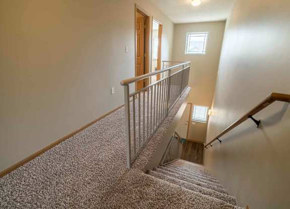 Stairwell to upstairs in a two-bedroom townhome at Southwind Villas in southwest Omaha in La Vista, NE, 68128