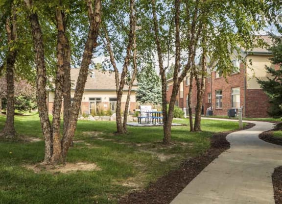 Scenic courtyard with mature trees and walking path  at Southwind Villas in southwest Omaha in La Vista, NE, 68128