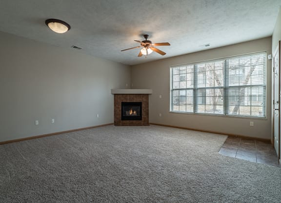 Spacious Large Living Room with Fireplace and abundant natural light at Stone Creek Villas Apartments in Omaha Nebraska