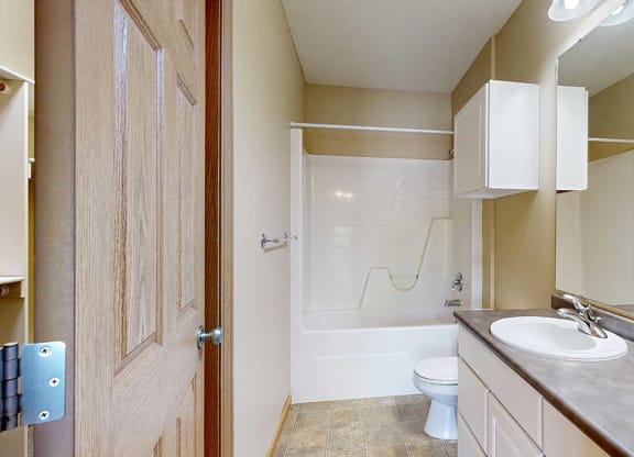 a bathroom with a toilet and a sink and a shower