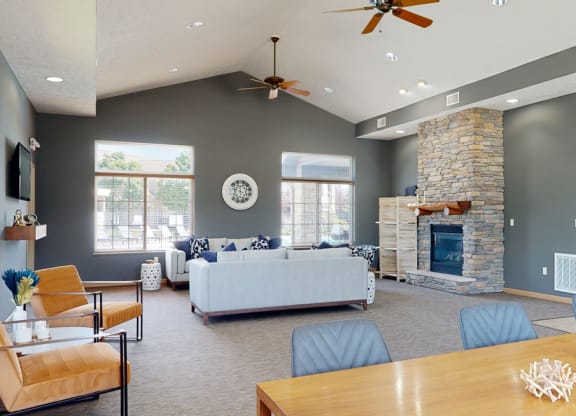 clubhouse living room with gray walls and a stone fireplace