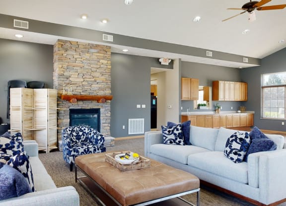 clubhouse living room with couches and a coffee table in front of a fireplace