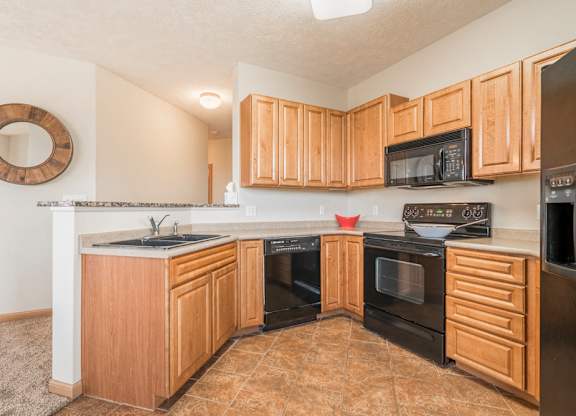 Interiors-Large kitchen with black appliances at Stone Ridge Estates townhomes in South Lincoln