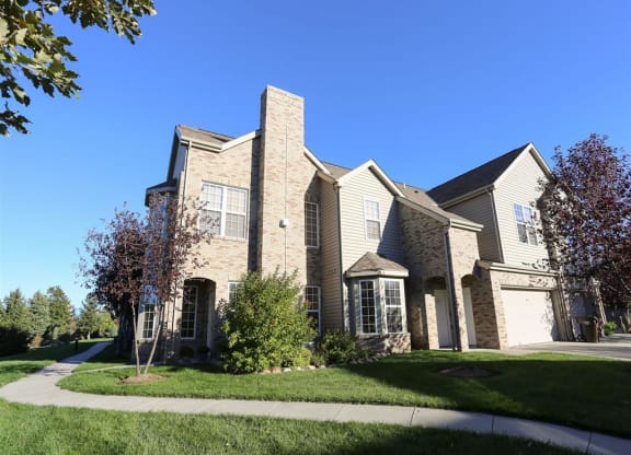 Exterior view of Stone Ridge townhomes with private entrance and attached garage