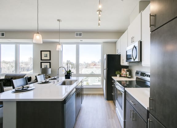 Kitchen with island and pendant lighting at The Central apartments near downtown Minneapolis MN 55408