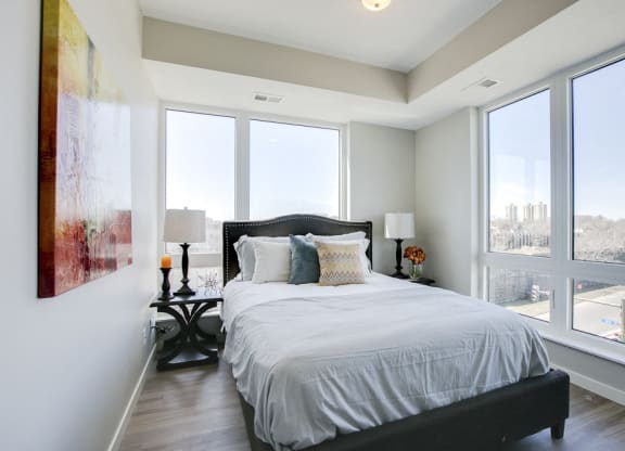 Bedroom with large windows and high ceilings at The Central apartments near downtown Minneapolis MN 55408
