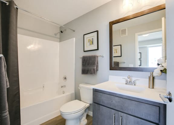 Bathroom with tub and quartz countertops at The Central apartments near downtown Minneapolis MN 55408