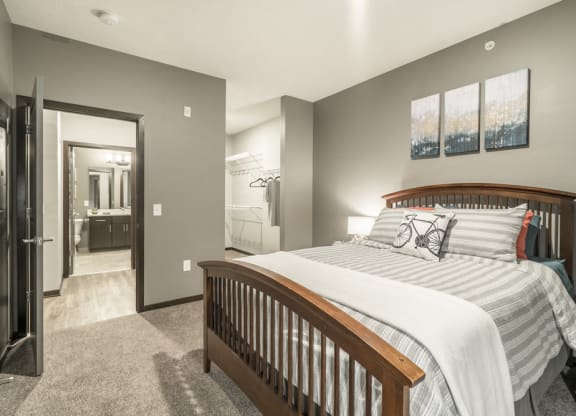 1-bedroom apartment with king-size bed and walk-in closet at The Conrad in Blackstone District Omaha