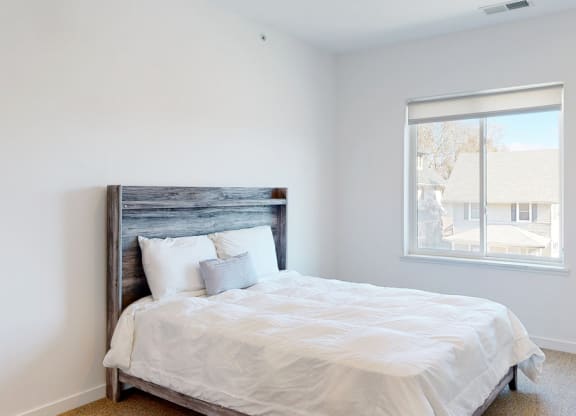 Furnished apartment bedroom with large single window