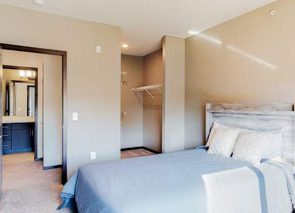 Furnished apartment bedroom with large walk in closet and easy bathroom access