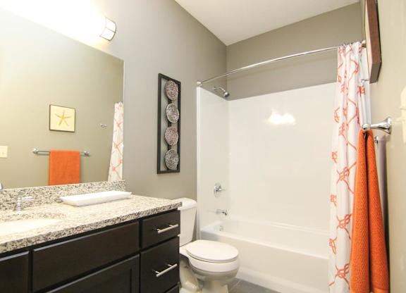 A bathroom with a toilet, sink, and shower.