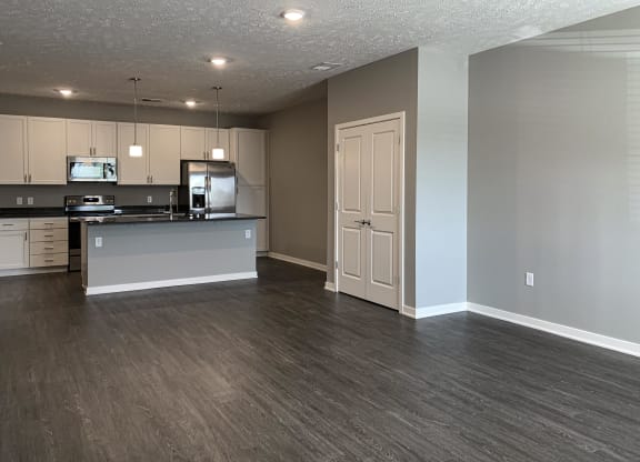 Living and dining area leading into the kitchen in the buffalo floorplan at the flats at shadow creek