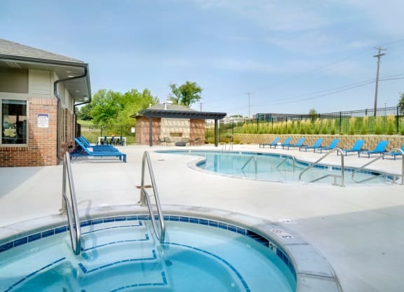 Resort style pool with lounge chairs outside the clubhouse at The Flats at Shadow Creek