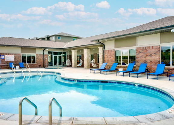 Resort style pool with lounge chairs outside the clubhouse at The Flats at Shadow Creek