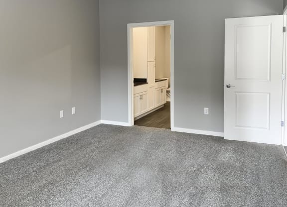 master bedroom with access to walk in closet and private bathroom The Flats at Shadow Creek in Lincoln Nebraska