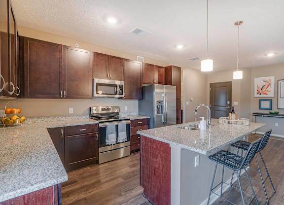 a kitchen with granite counter tops and stainless steel appliances