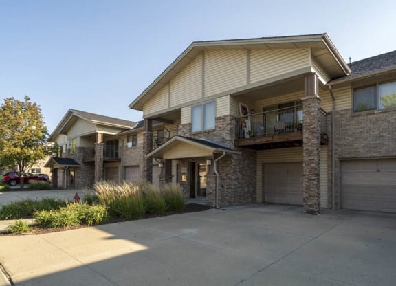Exterior view of townhome-style apartment with attached garages at Grand Legacy apartments and townhomes in west Omaha NE 68130