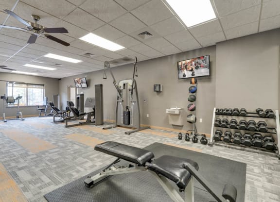 24-hour fitness center with free weights, TV and weightlifting machines  at Grand Legacy apartments and townhomes in west Omaha NE 68130