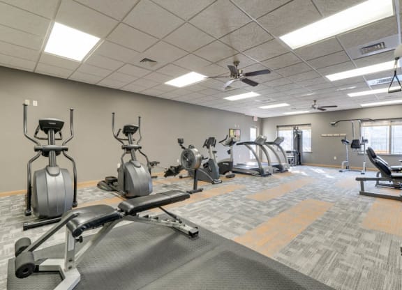 24-hour fitness center with cardio and weightlifting equipment