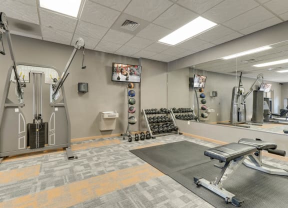 Fitness center with free weights and weightlifting equipment  at Grand Legacy apartments and townhomes in west Omaha NE 68130