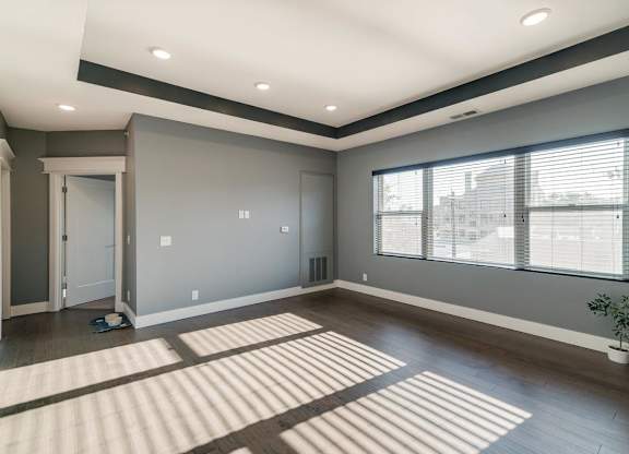 Living room with wide window and dark brown wood floors