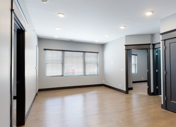 dining and living room space with light gray walls and a large window