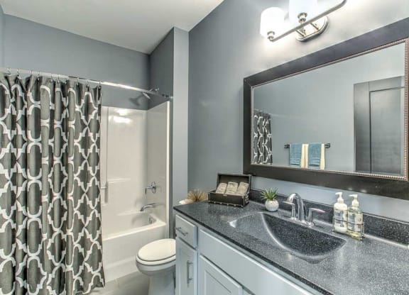 Bathroom with lots of cabinets for storage and a bathtub at The Helen