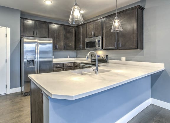 Updated kitchen with large counter top for breakfast bar seating at The Helen