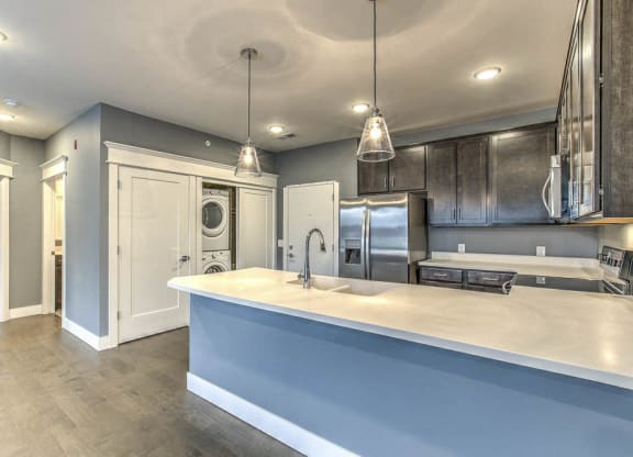 Large kitchen with plenty of counter space, including a washer and dryer in unit at The Helen