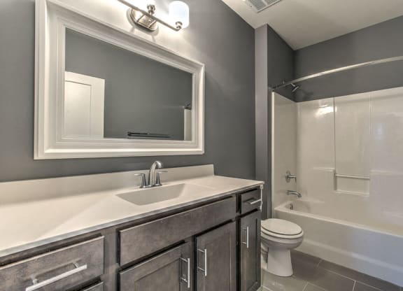 Bathroom with lots of counter space and a bathtub at The Helen